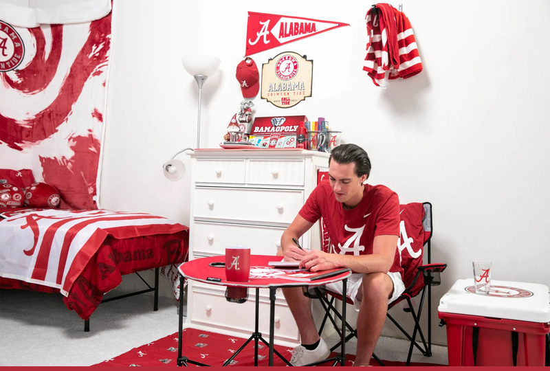 Illustration for article titled We Challenged Two Guys To Decorate A Dorm Room Using Only Fan Merch